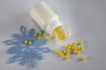 vitamin c in the form of yellow pills and a snowflake