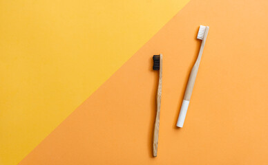 Two wooden toothbrushes on geometric background with copy space.
Top view of two different bamboo toothbrushes on multi colored background. Reusable, zero waste, plastic free, eco friendly dental care
