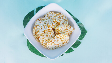 Keripik tempe is a traditional snack in Indonesia isolated on bright background