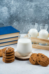 Delicious cookies with glass of milk and book