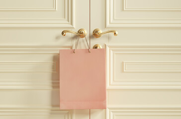 Empty paper shopping bag hang on doorknob. Business, retail, sale and commerce concept
