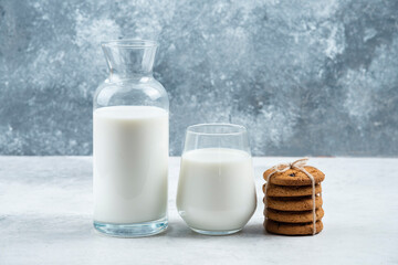 A glass and jar of milk with delicious cookies