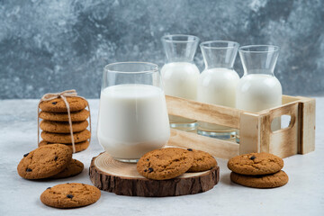 A glass cup with chocolate cookies on a wooden desk