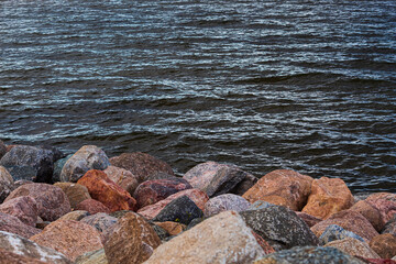 Stone seashore. Large texture stones on the seaside. Seascape
