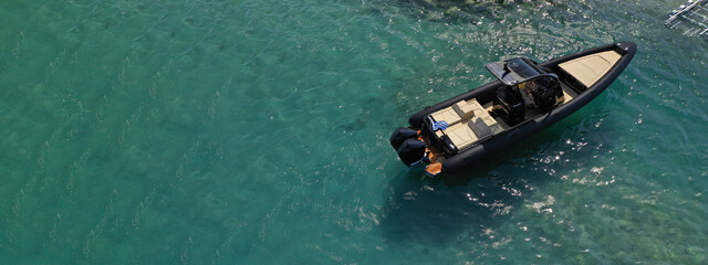 Aerial drone ultra wide photo of inflatable rib power boat anchored in tropical exotic emerald...