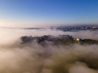 Misty morning in the countryside near Siena, Tuscany, Italy