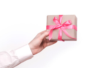 Gift box with pink ribbon in male hand
