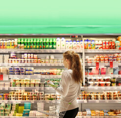 Woman choosing a dairy products at supermarket.