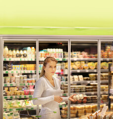 Woman choosing a dairy products at supermarket.