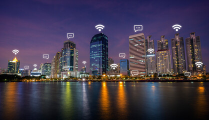 Fototapeta na wymiar Urban skyline of Bangkok, Thailand, at dusk. Wireless network connection, WiFi, smart city and online messaging concept image. 