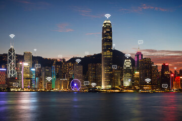 Urban skyline of the Hong Kong Island in Hong Kong, China, at dusk. Wireless network connection, WiFi, smart city and online messaging concept image.