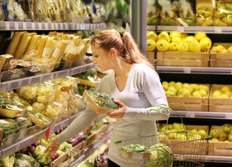 Woman buying fruits and vegetables at the market.
