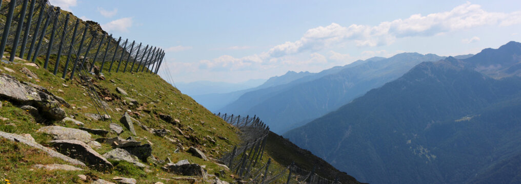 Panoramic view of avalanche protection structures on a mountain slope in the Alps, South Tyrol in Italy