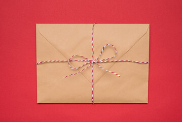 Photo of big package tied with striped red and white string ribbon isolated bright backdrop