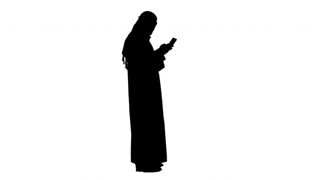 Arab man using his smartphone surfing on the internet or messaging, Alpha Channel