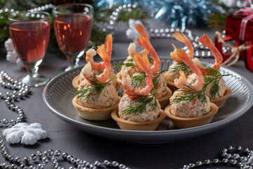 Tartlets with crab sticks, cheese and shrimps in the New Year's composition. Delicious festive snack. Closeup © Anzhela
