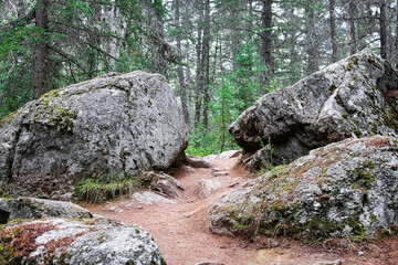 A hiking trail between two large boulders