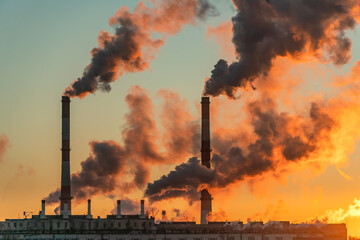 Polluting Factory at Dawn. Atmospheric air pollution from industrial smoke and dioxide.