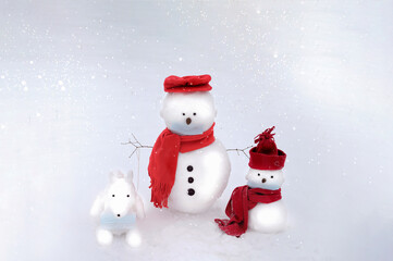 Snowmen and dog wearing a face mask on a white winter background. Christmas concept. Covid-19...