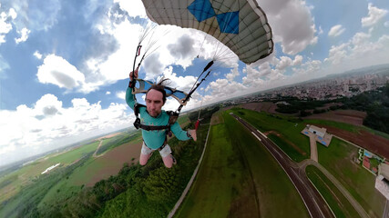 Unique images of a parachutist making selfie. Used a special camera with fish eye lens. Artistic...