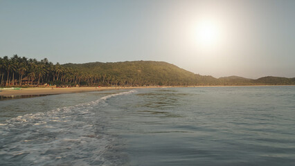 Sun over ocean bay waves aerial. Nobody nature seascape with green sea coast. Tropic forest at mountain of El Nido Island, Philippines, Asia. Cinematic summer vacation at paradise islet