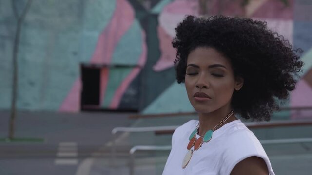 Black Afro Brazilian Woman Walking And Making Eye Contact, Slow Motion, Close Up