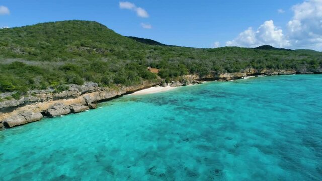Drone shot along coast with crystal clear waters in the Caribbean , Curacao