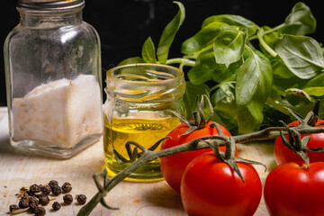 ingredients for baby basil pesto and vine cherry tomatoes salt olive oil and pepper cordoba argentina