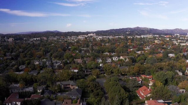 Wide aerial rising shot of Pasadena neighborhood. HD at 60 FPS.
