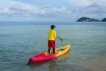 Lifeguard man on kayak boat in beach
