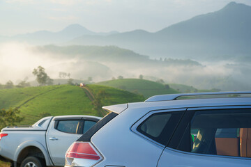Naklejka premium Outdoor travelling cars on top hill with mountains on background in Asia