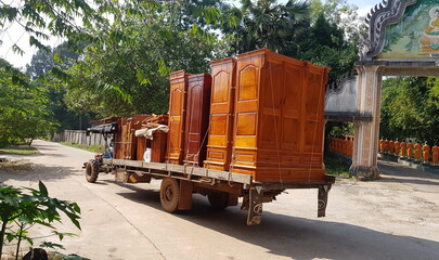 Cambodia. Often in Cambodia, you can see how Khmers transport cargo on a walk-behind tractor. Siem Reap province.