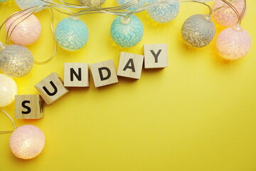 Sunday alphabet letter with LED Cotton ball Decoration on yellow background