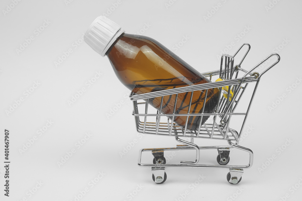 Wall mural medicine on shopping cart on white background