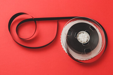 Naklejka premium Roll of Film. Tape roll with red background