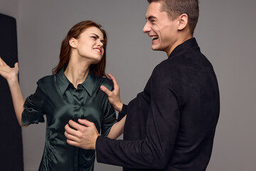 cheerful man and aggressive woman slap in the face conflict gray backgroun