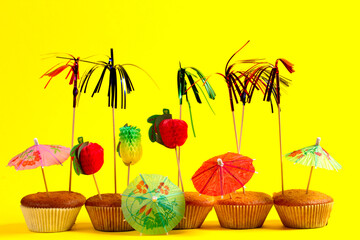 Delicious fresh cupcake with accessories on yellow