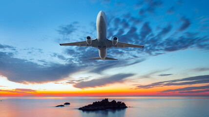 Airplane in the sky at amazing sunset