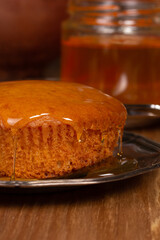 Delicious fresh cupcake with honey on the table