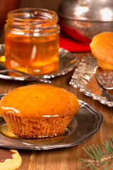 Delicious fresh cupcake with honey on the table