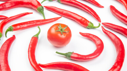 Red hot chili peppers and tomato over white background. Vitamin vegetable food