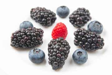 Blackberry, raspberry blueberry and strawberry on a white background. Vitamins and wholesome foods