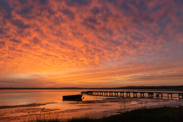 Red sky at dawn on the lake side.