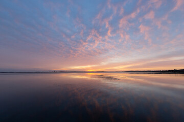 Colorful sunrise sky with reflection on the lake.