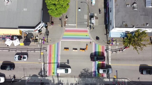 aerial birds eye view fly over downtown Vancouver Gay Pride Village the West End where iconic LGBTQ flag paved on intersection of Davie and Bute on a sunny afternoon 1-4