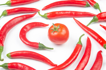 Red hot chili peppers and tomato over white background. Vitamin vegetable food