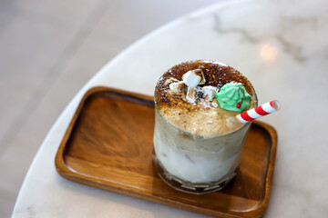 Milky Caramel drink with marshmallows and sugar Santa dolls.