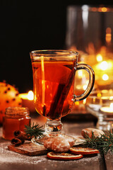 Glass of Christmas tea with cloves and cinnamon.