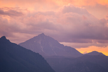 Landscape of mountain peaks in sunset colors