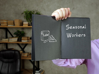  Juridical concept meaning Seasonal Workers with phrase on the piece of paper.